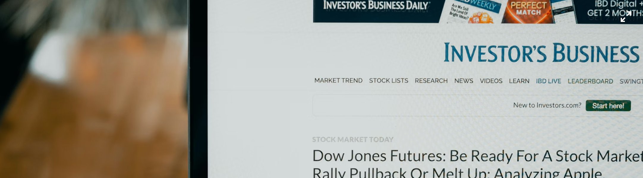 Investor reviewing financial news to research private banking versus independent wealth management options in New England